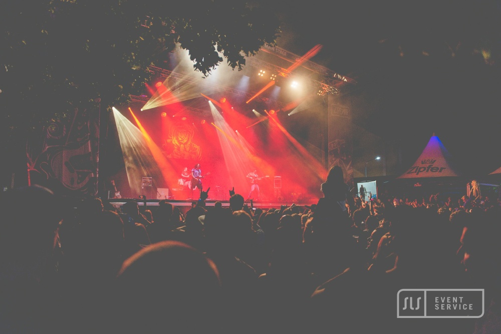 Open-Air-Konzert mit Live-Band, großem Publikum und roter Bühnenbeleuchtung von SLS Eventservice